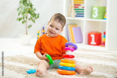 Baby toddler boy playing in...