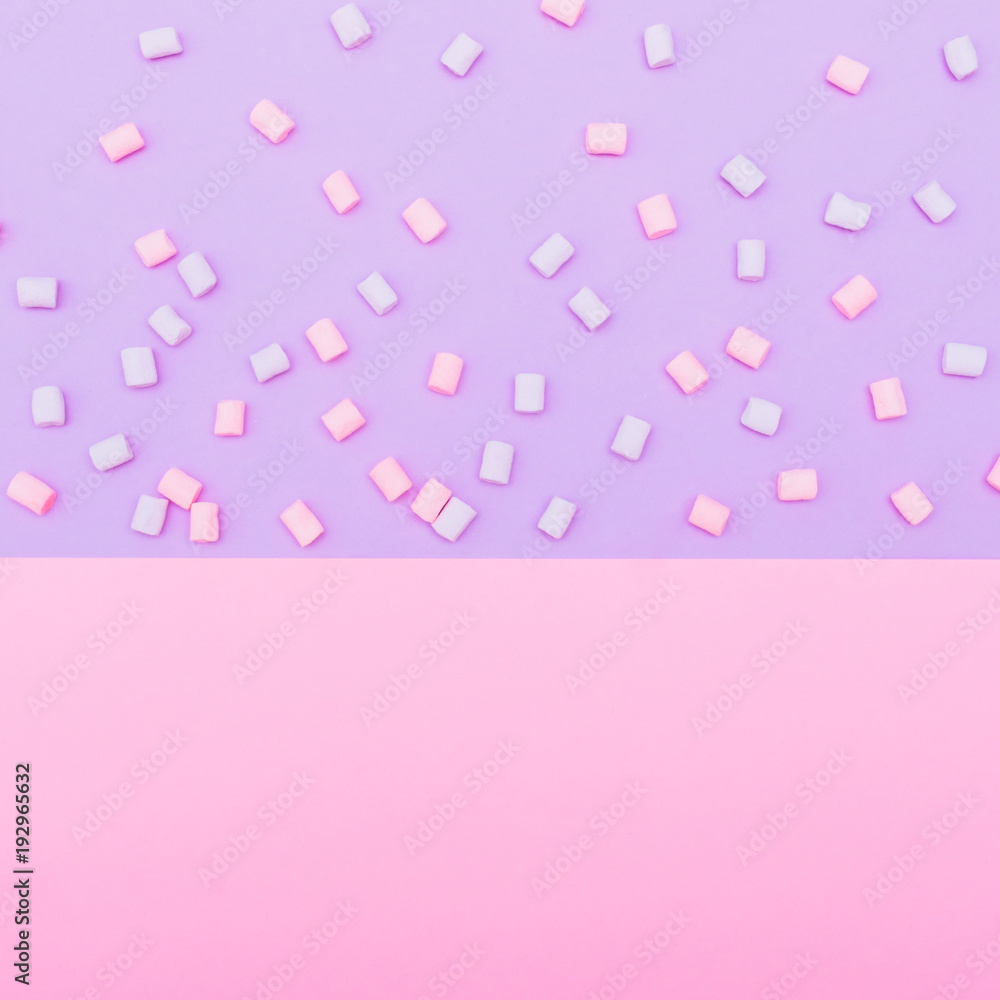 colorful marshmallow laid out on blue and pink background. pastel creative textures. minimal colorful marshmallow laid out on blue and pink background. pastel creative textures. minimal