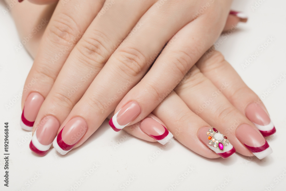 Manicure. White nails with red hearts. Isolated.