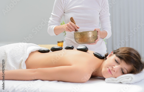 hot stone massage with sound bowl in spa center