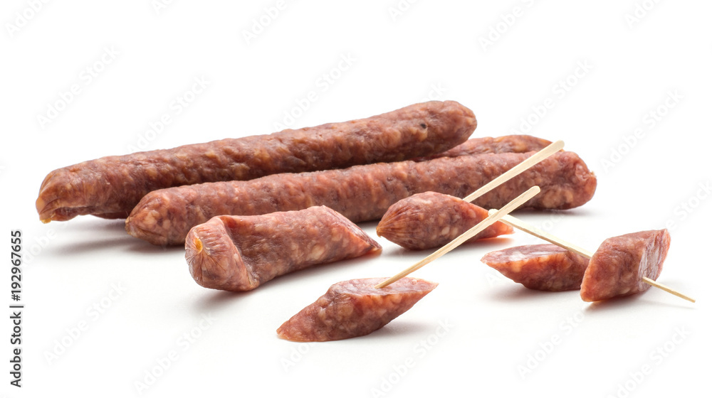 Hungarian dry sausages pepperoni isolated on white background smoked in natural casing mixed pork and beef whole and cut in pieces like canape. Hungarian dry sausages pepperoni isolated on white background smoked in natural casing mixed pork and beef whole and cut in pieces like canape.