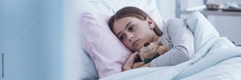 Sick girl hugging plush toy Sick girl hugging plush toy