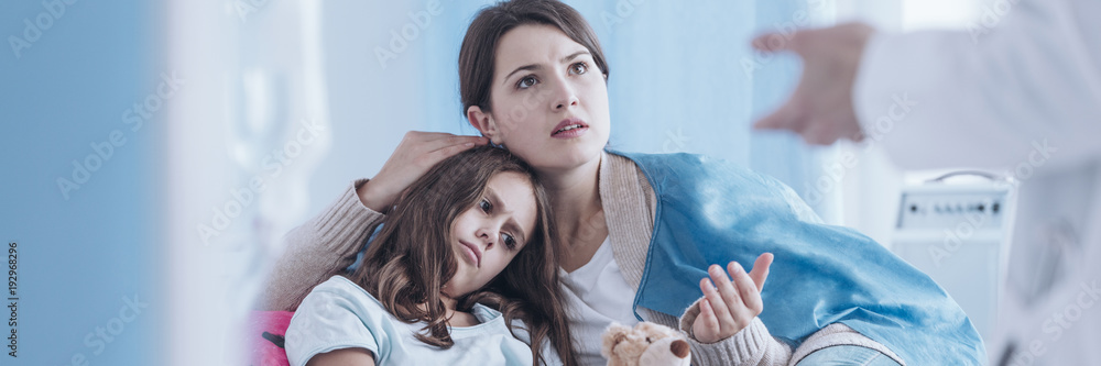 Caring mother talking with doctor Caring mother talking with doctor