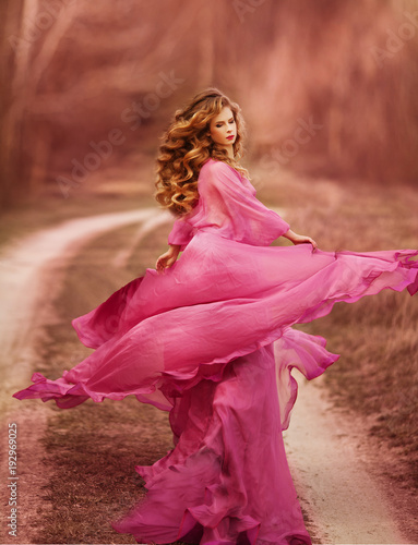 Portrait of sexy young beautiful caucasian blonde in pink dress on white background