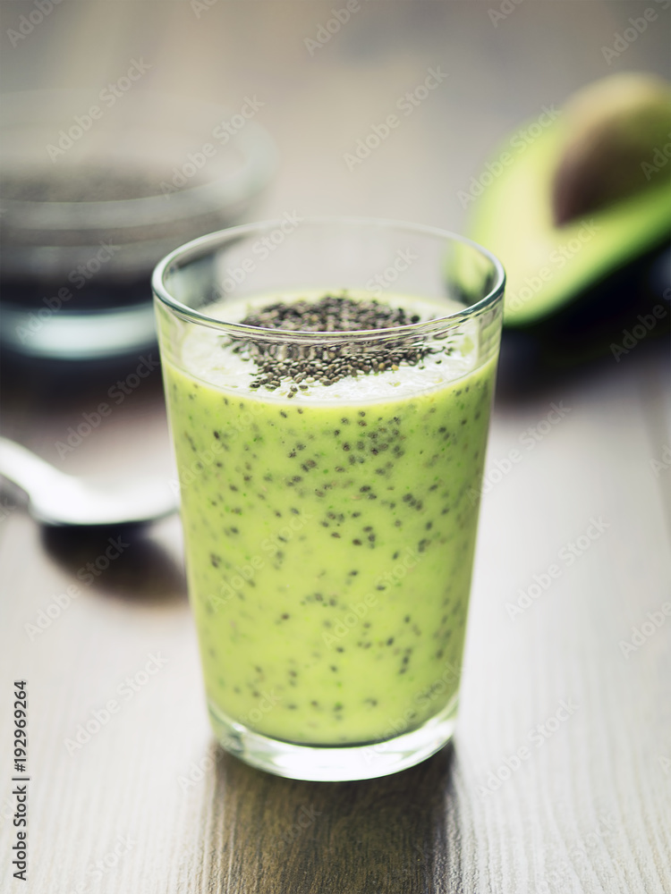 Avocado chia pudding in a glass on dark rustic background