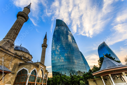 Turkish mosque of the Martyrs and modern glass central business district skyscrapers in the sunset, Baku, Azerbaijan photo