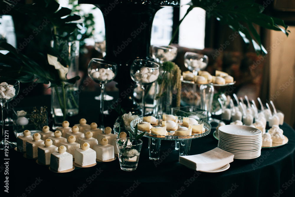elegant dessert table at the wedding. black decoration