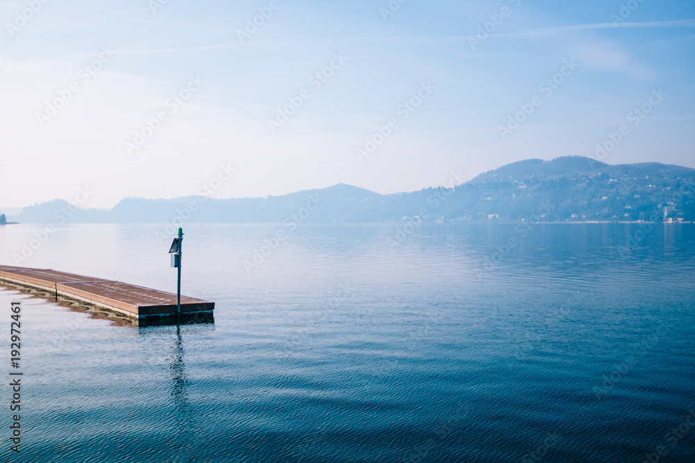 floating jetty with background the lake and mountains on a bright morning
