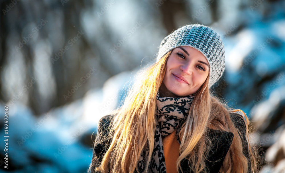 Young woman in the winter park at sunny day, warm clothes Young woman in the winter park at sunny day, warm clothes