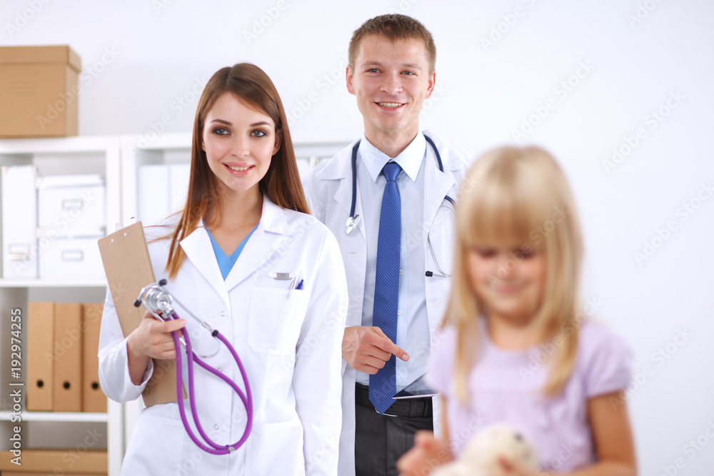 Female doctor examining child with stethoscope at surgery Female doctor examining child with stethoscope at surgery