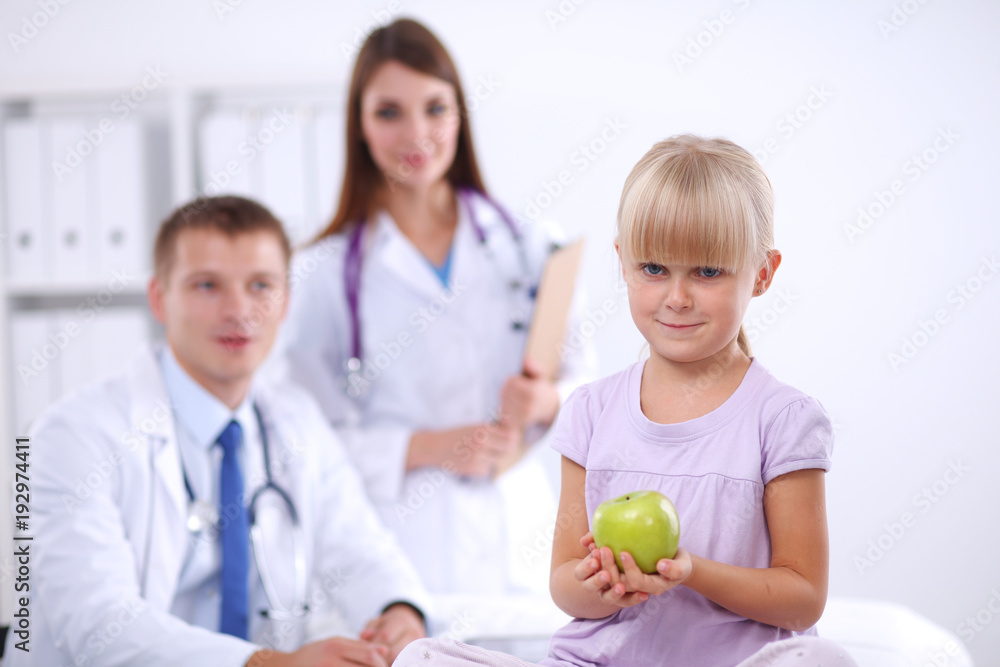 Female doctor examining child with stethoscope at surgery Female doctor examining child with stethoscope at surgery