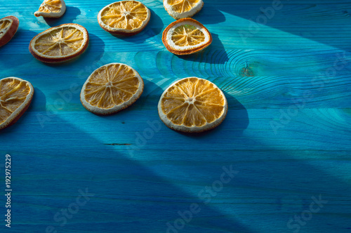 orange slices on blue wooden background