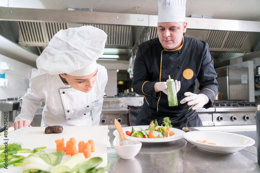 Chef Cooking, Cutting and preparing next plate Chef Cooking, Cutting and preparing next plate