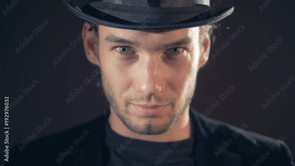 Mystical portrait of a man. Mystical man in hat looking into camera in the dark. 4K. Mystical portrait of a man. Mystical man in hat looking into camera in the dark. 4K.