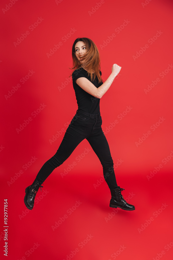 Full length of a casual girl jumping Full length of a casual girl jumping