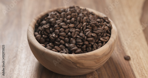 coffee beans in wood bowl on table