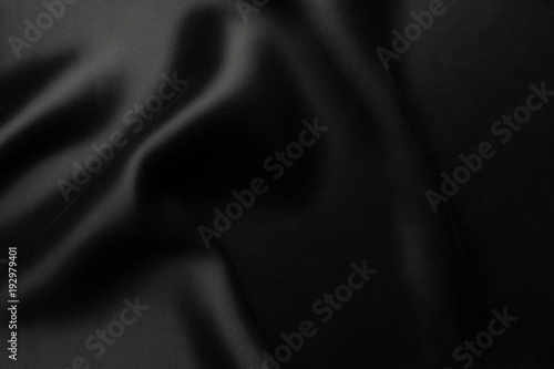 Elegant black satin silk with waves, abstract background