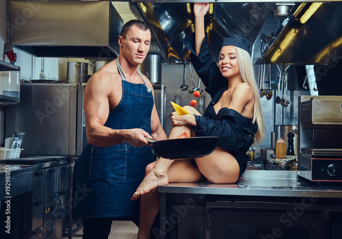 A sexy waitress flirts with an attractive cook.