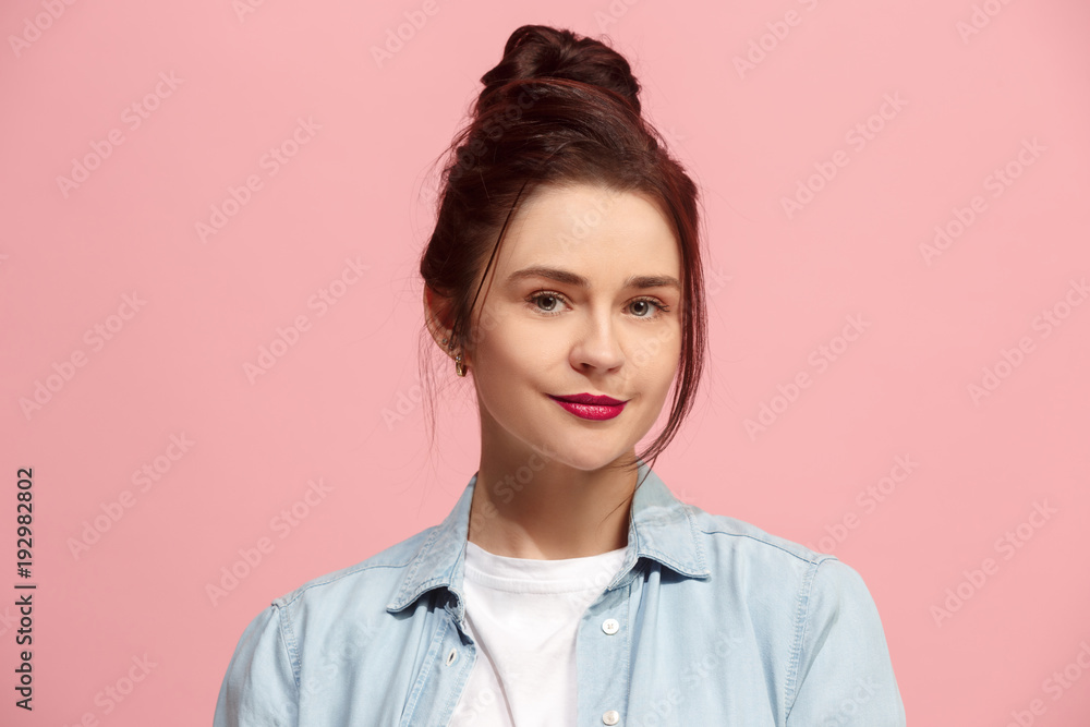The happy business woman standing and smiling against pink background. The happy business woman standing and smiling against pink background.