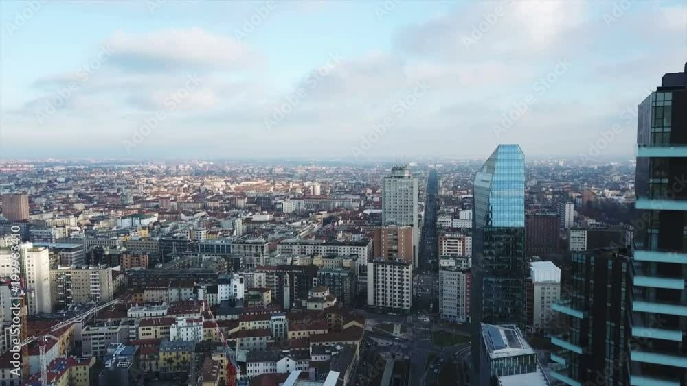 milan aerial view at sunrise, flying over the skyscrapers milan aerial view at sunrise, flying over the skyscrapers