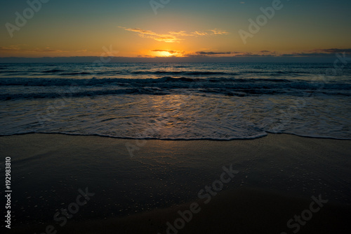 Fototapeta Naklejka Na Ścianę i Meble -   sunset or sunrise on the sea with a sandy beach. Calm sea at dusk