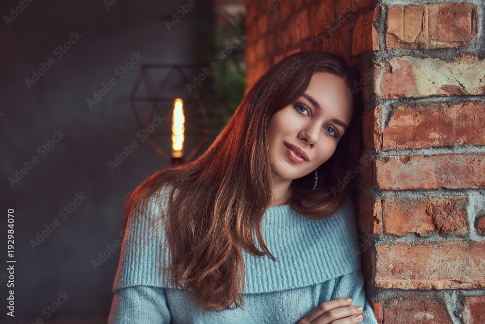 A sensual brunette in a gray sweater A sensual brunette in a gray sweater
