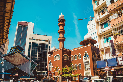 Kuala Lumpur cityscape. Religious and modern architecture. Travel to Malaysia. Mosque Masjid India. City tour. Street market area. Tourism industry. Building facade. Urban background. Street scene