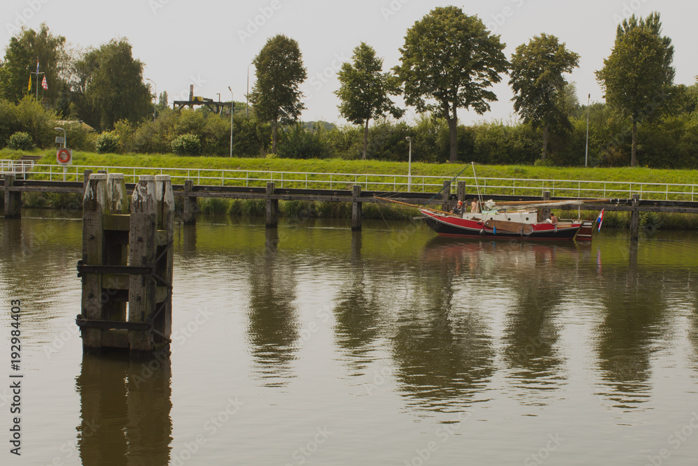 Particular boat on Holland canal in front of dutch style