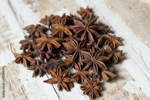 star anise is poured on a light wood surface