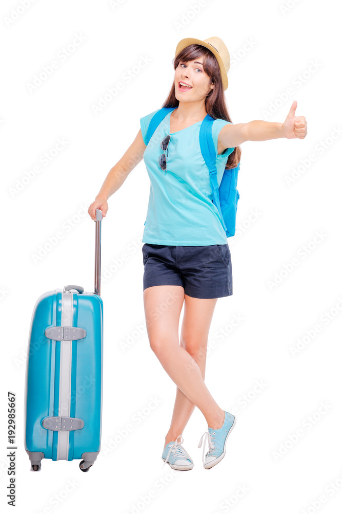 Travel and hitch-hiking concept. Studio portrait of happy pretty young woman showing thumb up. Isolated on white. Travel and hitch-hiking concept. Studio portrait of happy pretty young woman showing thumb up. Isolated on white.