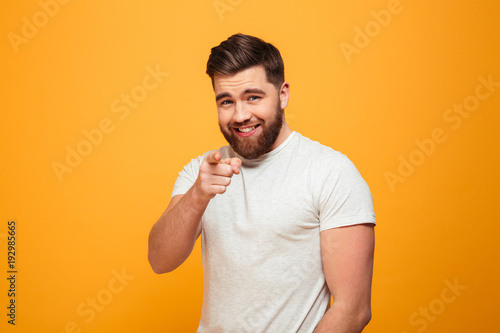 Portrait of a smiling bearded man pointing finger