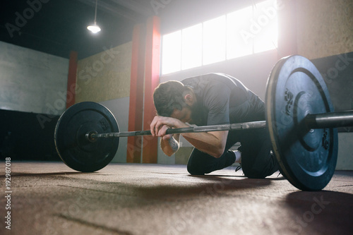 Athlete man with a beard exercising in a gym