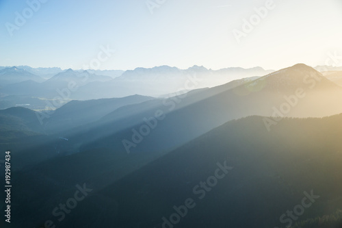 Panoramic view from Herzogstand with the mountainscape with foggy sunset.