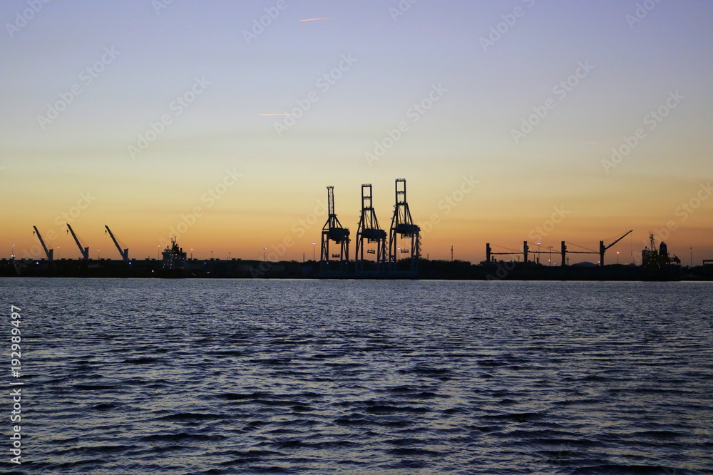 Obraz premium Port cranes in Jacksonville from across the St. Johns River