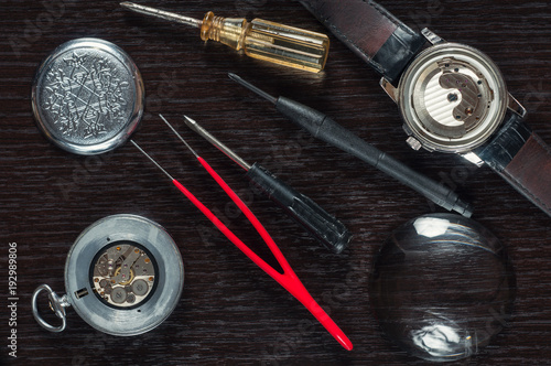 old watch repair composition with magnifier and screwdrivers
