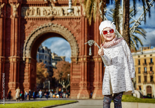 happy modern child in Barcelona, Spain showing thumbs up photo