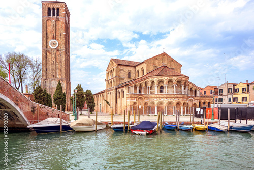 Daylight view to parked boats and historic architecture building photo
