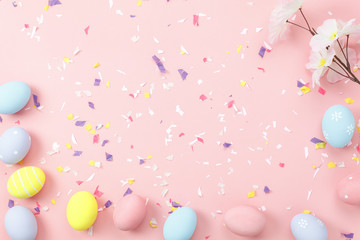 Top view shot of arrangement decoration Happy Easter holiday background concept.Flat lay colorful bunny eggs with accessory ornament on modern beautiful pink paper at office desk.Design pastel tone.