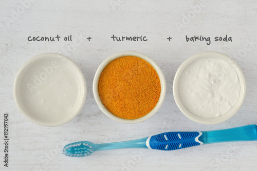 Homemade teeth whitening recipe made out of coconut oil, turmeric and baking soda photo