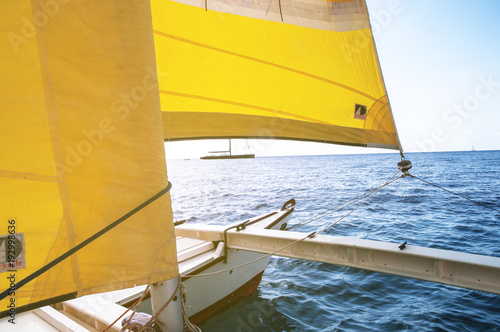 Going Sailing on a catamaran with yellow sails in Ibiza