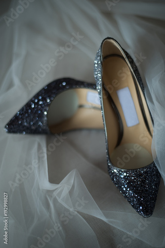 Elegant bridal shoes and a veil,selective focus.