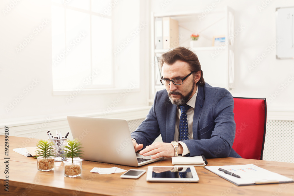 Concentrated businessman working with laptop Concentrated businessman working with laptop