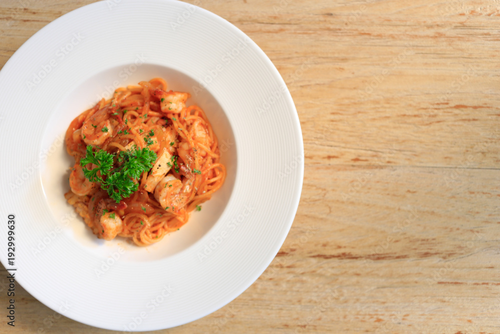Top view SpaghettiMarinara on wooden background. Top view SpaghettiMarinara on wooden background.