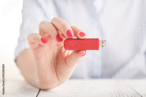 Close up view of usb flash pendrive in female hand photo
