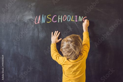 Concept Unschooling Home Learning Back To School Color Chalk on Black Blackboard Background in Row Top View Flat Lay