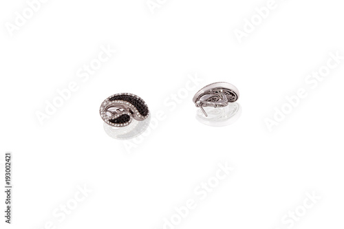 Platinum precious earrings female with diamonds on white isolated background.