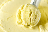 Vanilla ice cream scoop background. Summer food concept, copy space, top view. Scooped texture. Scooping out yellow ice-cream.