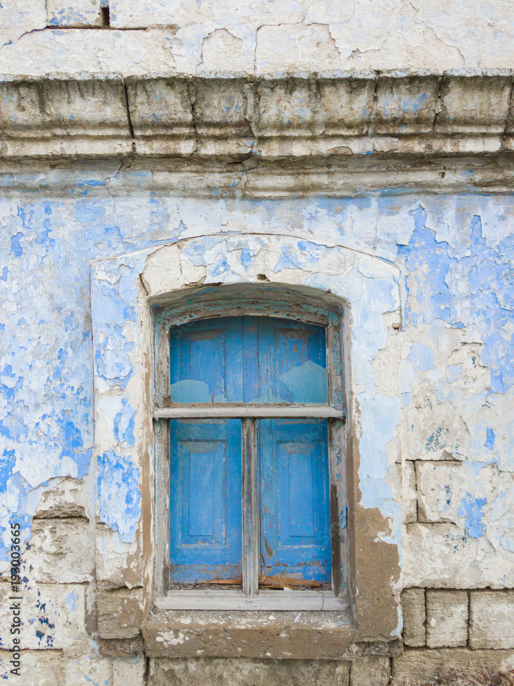 Old wooden window blinds / Window with blue wooden shutters in old abandoned brick house Old wooden window blinds / Window with blue wooden shutters in old abandoned brick house