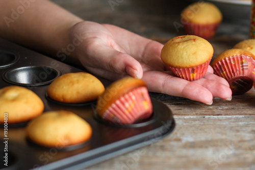 small muffins (cupcakes) - fresh pastries on a wooden surface