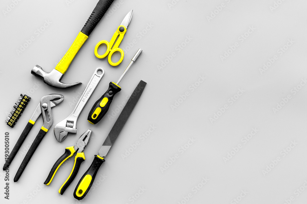 Repair tools. File, hummer on grey background top view copy space pattern Repair tools. File, hummer on grey background top view copy space pattern